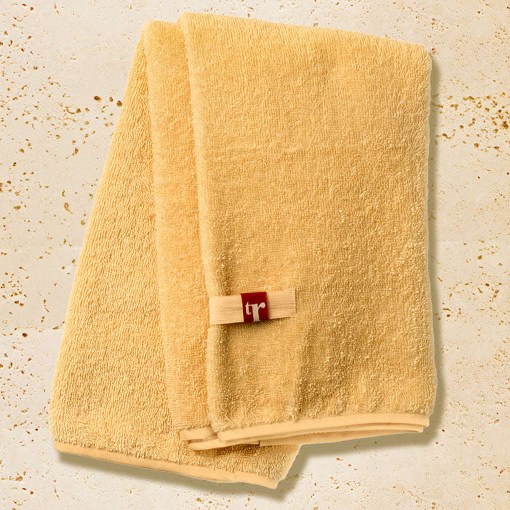 Organic hair towel in yellow with TR brand initials